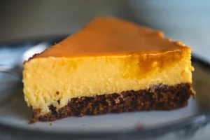 Porción de chocoflan artesanal con capa de flan de vainilla y bizcocho de chocolate, bañado en caramelo, servido en un plato de Panadería El Molino.